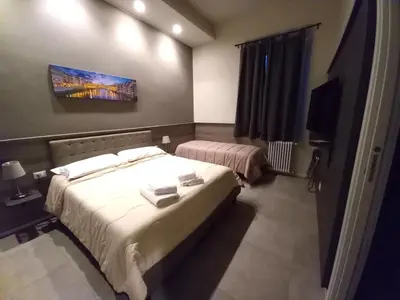 Letto o letti in una camera di La Corte di Firenze Bed and Breakfast