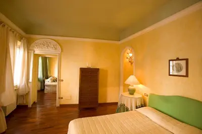 Letto o letti in una camera di Palazzo Bianchini