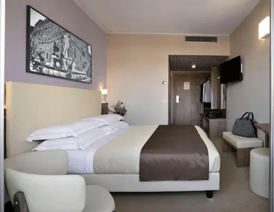 Letto o letti in una camera di Hotel Raffaello