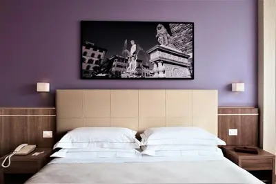 Letto o letti in una camera di Hotel Raffaello