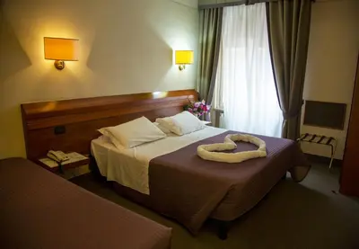 Letto o letti in una camera di Hotel Arcadia